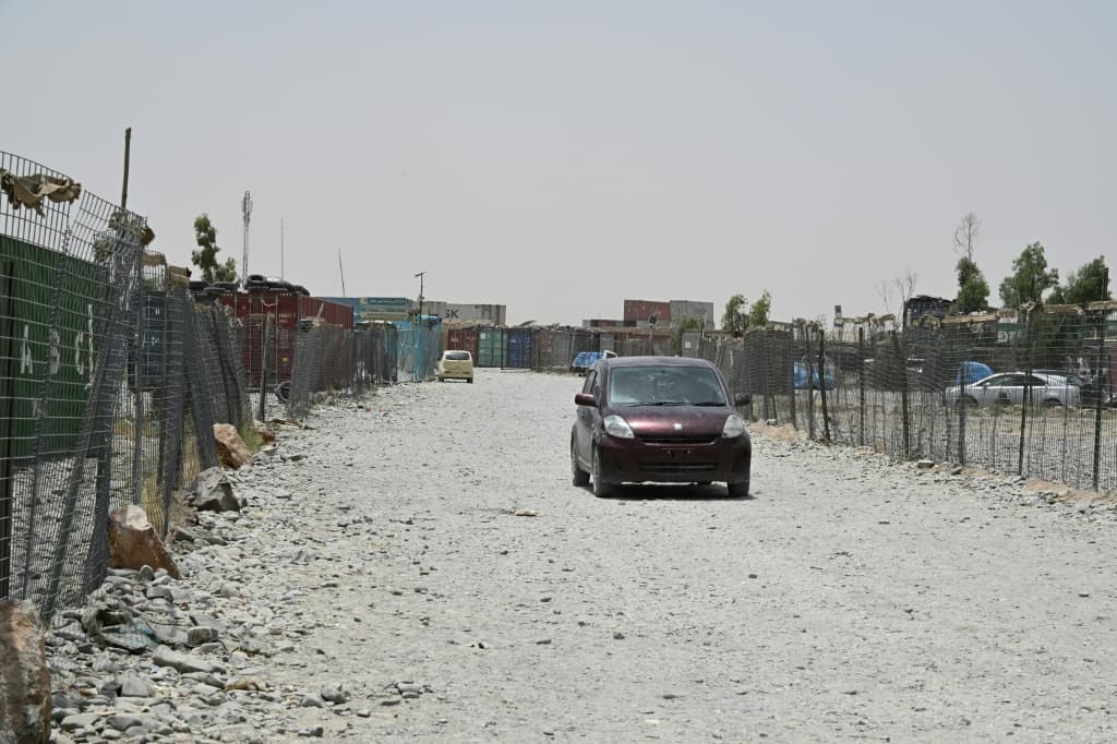 A car driving through a vacant container yard in the Spin Boldak district of Afghanistan's Kandahar province