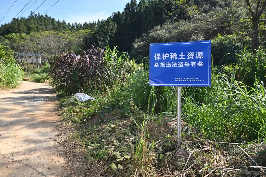 Signage announcing a reward for those who report illegal rare earth mining activities, in Dingnan County in eastern China