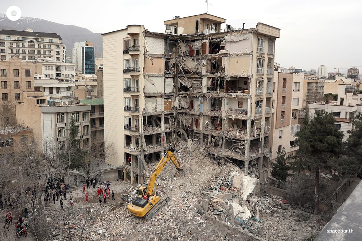 รถขุดกำลังเคลียร์ซากปรักหักพังจากอาคารที่พักอาศัยที่ถูกทำลายในทางตอนเหนือของกรุงเตหะราน เมื่อวันที่ 23 มีนาคม 2026 Photo by - / AFP
