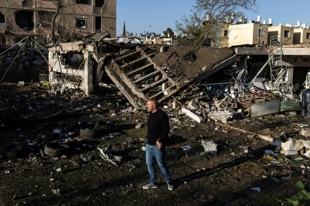 A man surveys the damage in Dimona after Iranian missiles slipped through air defences and struck two towns in southern Israel