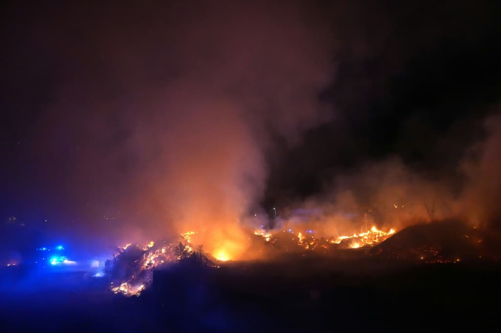 Two major blazes have merged near Madrid, with the smell of burning reaching the Spanish capital
