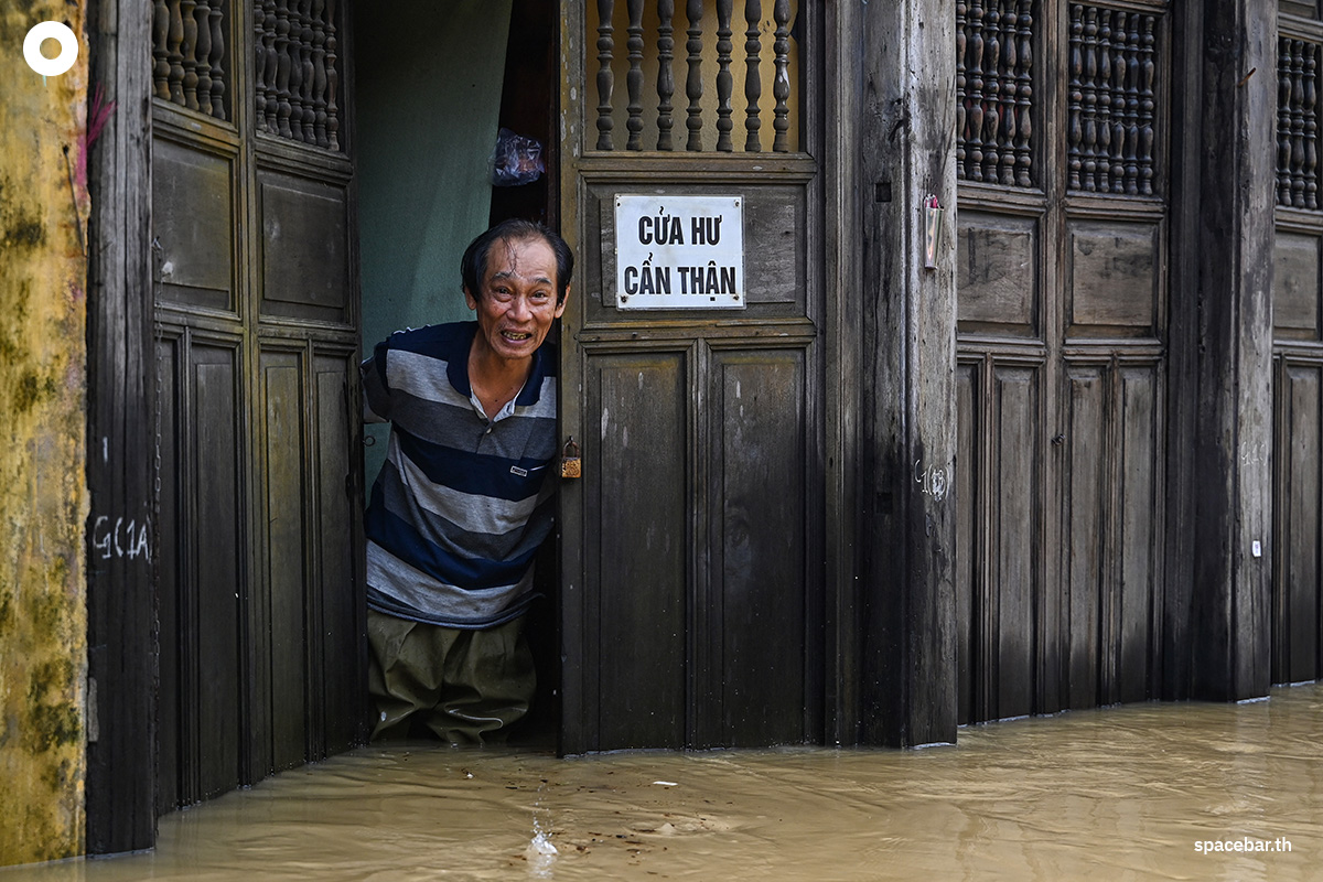 PhotoStory-   ชายคนหนึ่งยืนอยู่ท่ามกลางน้ำท่วมบริเวณทางเข้าร้านค้าของเขา หลังจากฝนตกหนักในเมืองฮอยอัน เมื่อวันที่ 30 ตุลาคม 2025 (Photo by NHAC NGUYEN / AFP) 