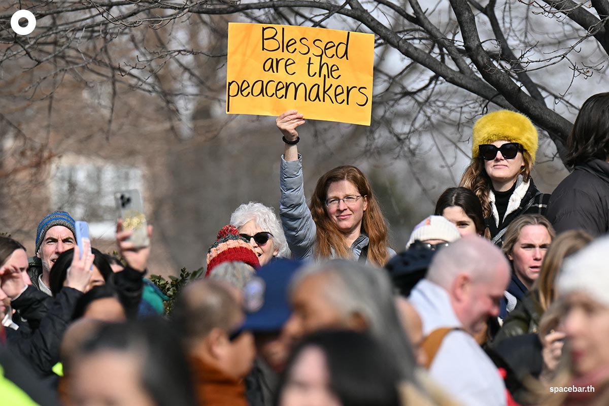 PhotoStory-หญิงคนหนึ่งถือป้ายขณะที่พระภิกษุสงฆ์เดินทางมาถึงมหาวิหารแห่งชาติวอชิงตันในกรุงวอชิงตัน ดี.ซี. เมื่อวันที่ 10 กุมภาพันธ์ 2026 (Photo by Drew ANGERER / AFP)